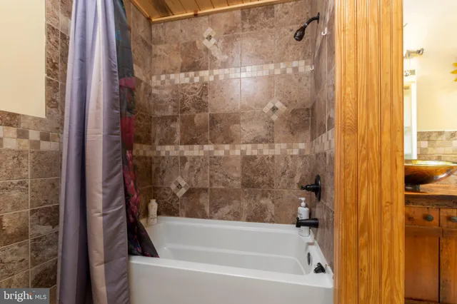 a bathroom with a bathtub and a shower