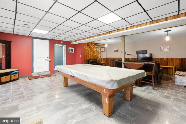 a room with pool table and windows