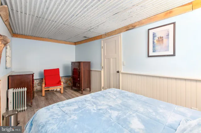 a bedroom with furniture and wooden floor