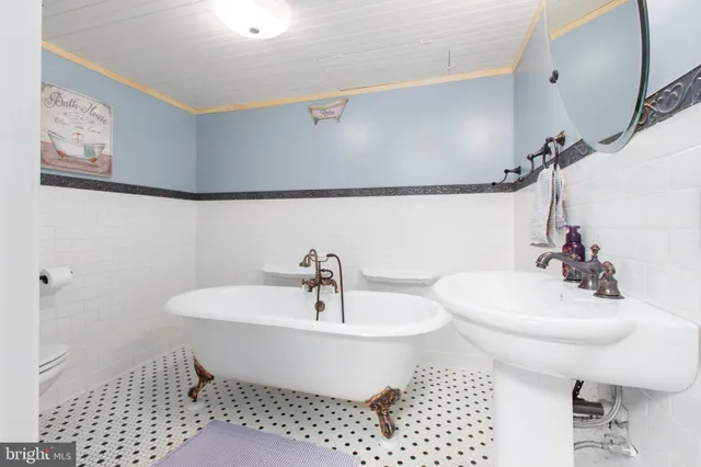 a bathroom with a sink toilet and a mirror