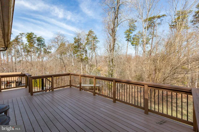 a view of balcony with wooden floor and fence