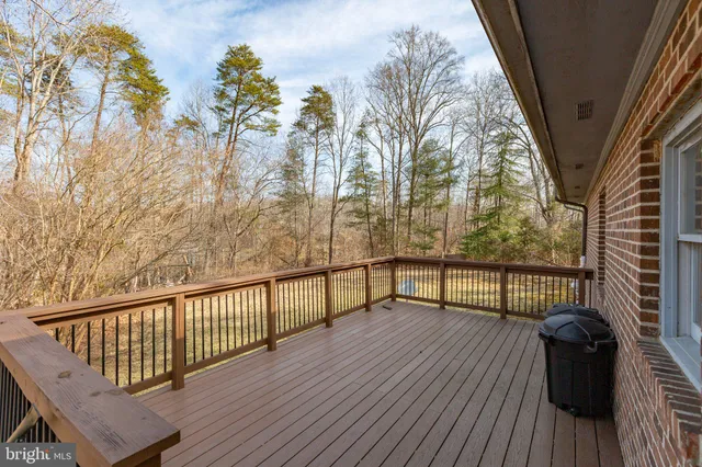 a view of balcony with wooden floor and fence