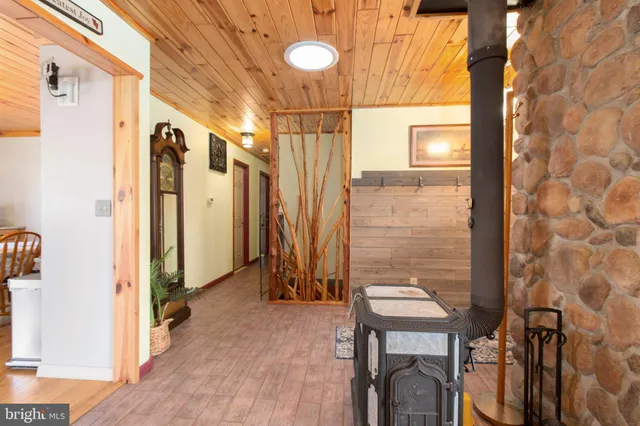 a view of a hallway with wooden floor and entryway