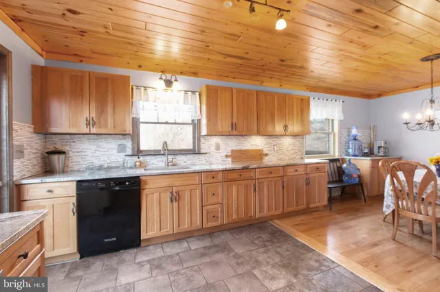 a kitchen with granite countertop sink cabinets and stainless steel appliances