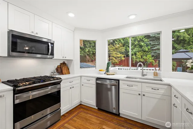 a kitchen with a sink stove and microwave