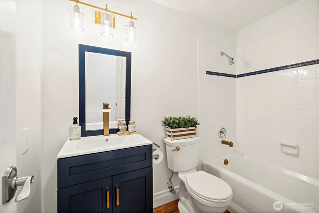 a bathroom with a sink vanity mirror and toilet