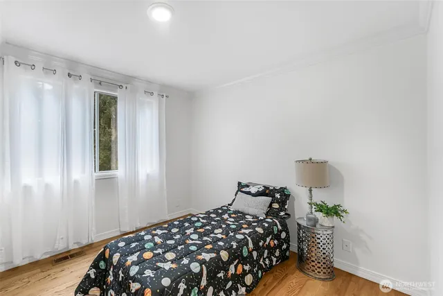 a bedroom with bed and a window