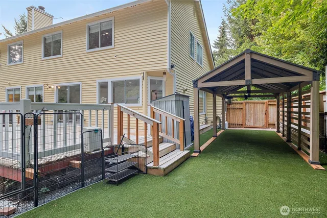 a view of a house with a yard and deck