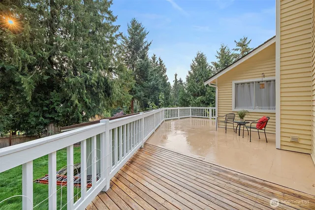 a view of a chairs and table on the wooden deck