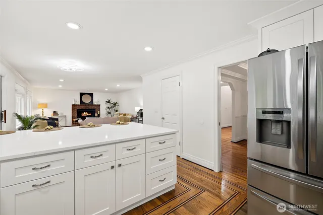 a kitchen with stainless steel appliances a refrigerator sink and cabinets