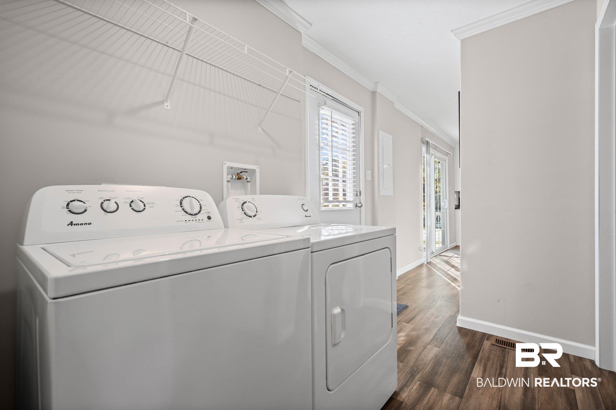 1325 Ridgewood Drive Lillian, AL 36549 - Photo 14 of 32 Washroom with crown molding, washing machine and clothes dryer, and dark wood-type flooring