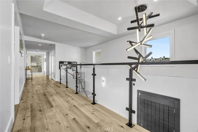 a view of a hallway view with wooden floor and furniture