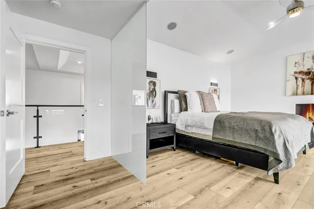 a bedroom with a bed and wooden floor