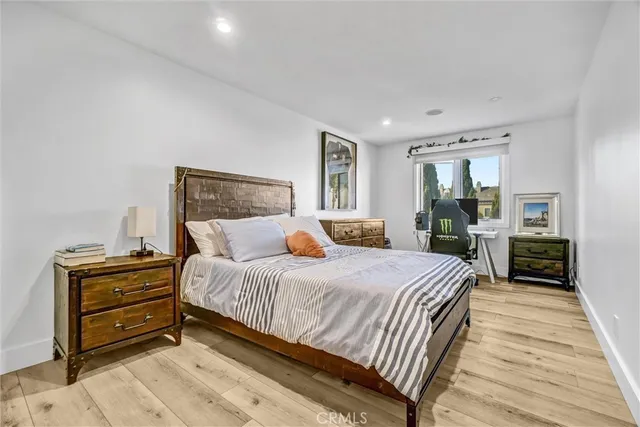 a bedroom with a bed and a painting on the wall
