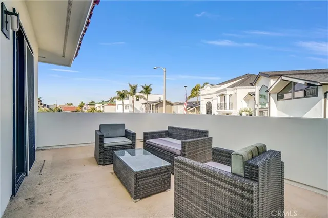 a view of a patio with table and chairs potted plants with floor to ceiling window