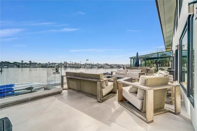 a view of a patio with couches potted plants and pool
