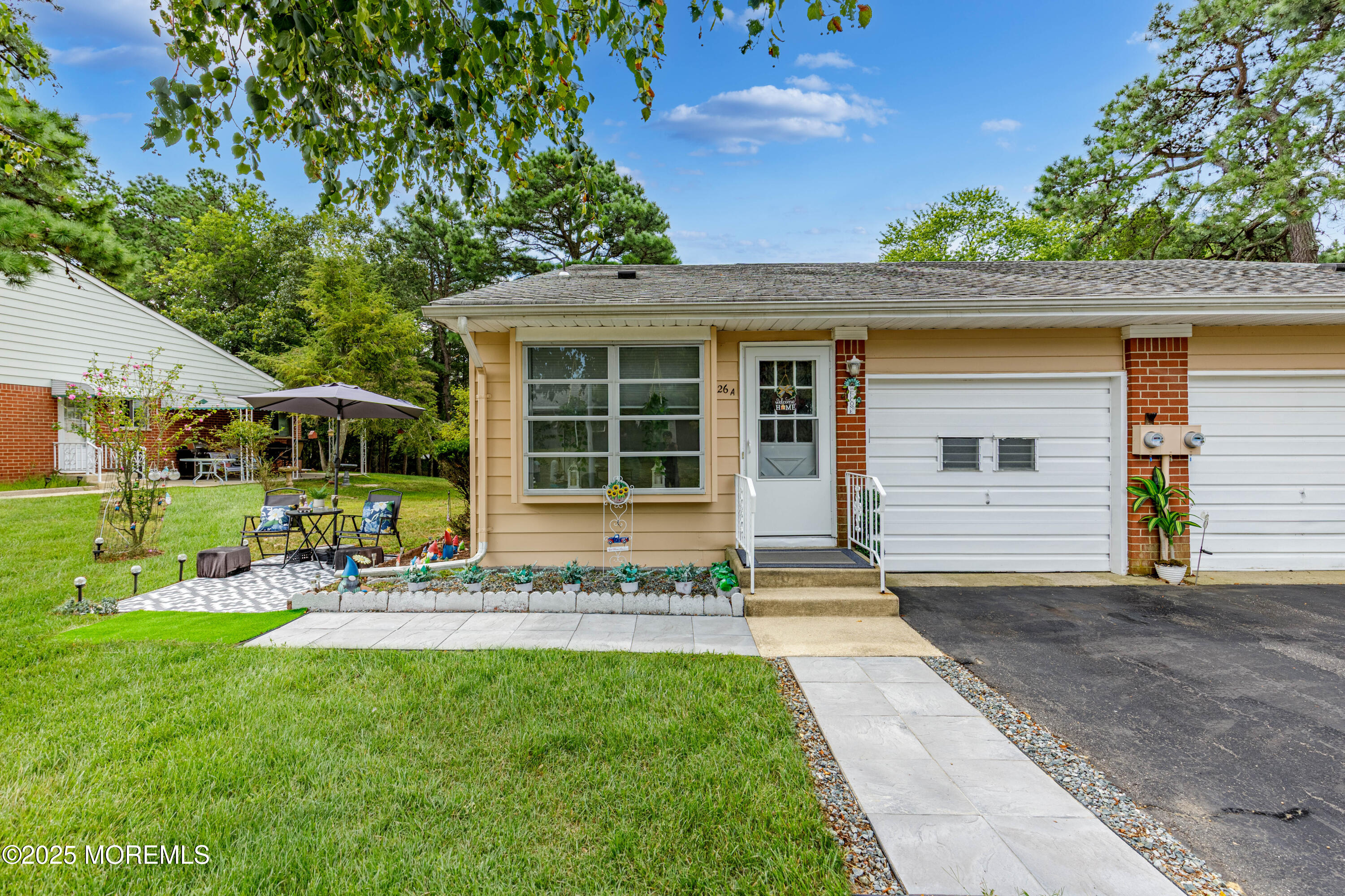 26 Salem Drive, Unit A Whiting, NJ 08759 - Photo 2 of 23 a front view of a house with a garden and plants