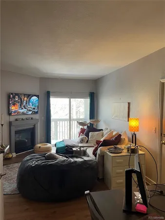 a bedroom with a bed a fireplace and a window
