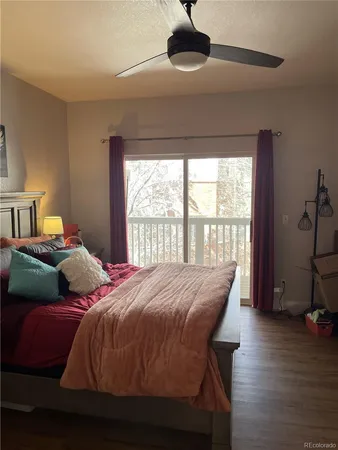 a view of a livingroom with wooden floor and a ceiling fan