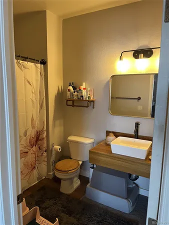 a view of a room with wooden floor and bathroom