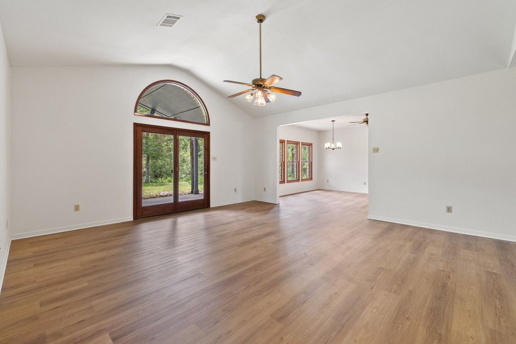 244 Woodway Elgin, TX 78621 - Photo 10 of 40 wooden floor in an empty room with a window