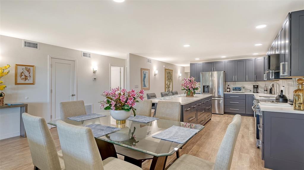 5757 Gulf Of Mexico Drive, Unit 204 Longboat Key, FL 34228 - Photo 25 of 71 a kitchen with a dining table cabinets appliances and kitchen view