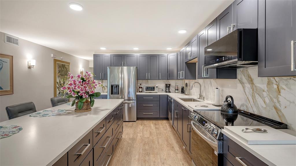 5757 Gulf Of Mexico Drive, Unit 204 Longboat Key, FL 34228 - Photo 26 of 71 a kitchen with a sink stainless steel appliances and cabinets