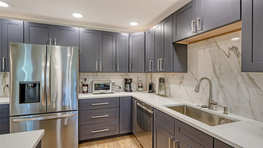 5757 Gulf Of Mexico Drive, Unit 204 Longboat Key, FL 34228 - Photo 27 of 71 a kitchen with a refrigerator sink and cabinets