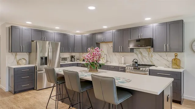 a bathroom with a granite countertop sink a shower and a mirror