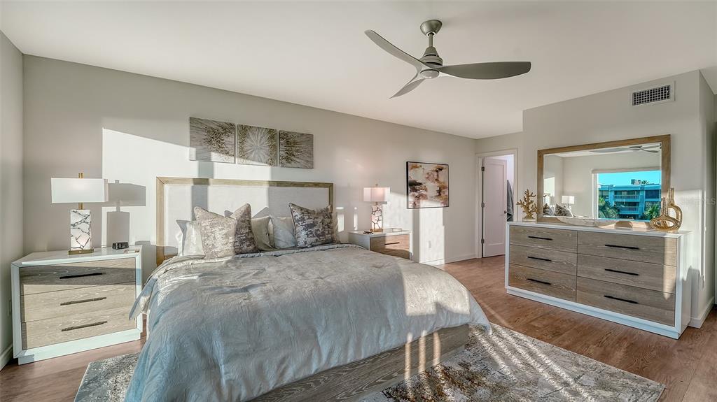 5757 Gulf Of Mexico Drive, Unit 204 Longboat Key, FL 34228 - Photo 36 of 71 a bed room with a bed and a dresser