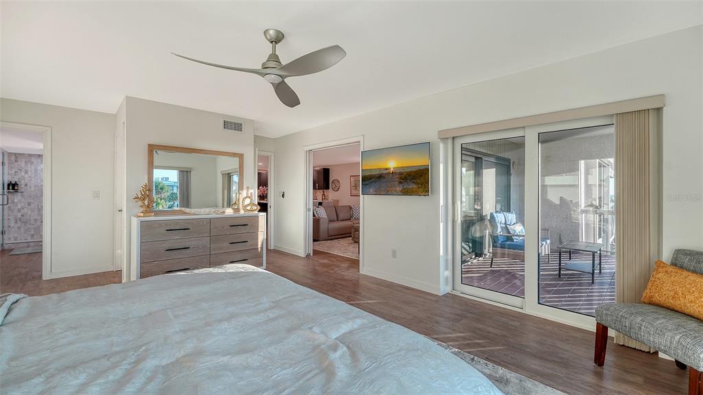 5757 Gulf Of Mexico Drive, Unit 204 Longboat Key, FL 34228 - Photo 37 of 71 a spacious bedroom with a bed and a view of bathroom