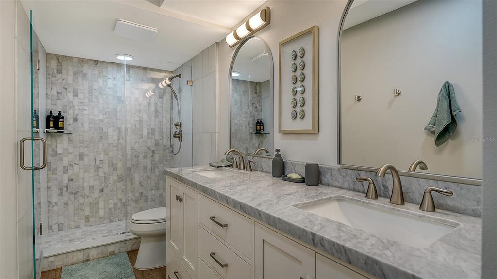 5757 Gulf Of Mexico Drive, Unit 204 Longboat Key, FL 34228 - Photo 41 of 71 a bathroom with a granite countertop sink a toilet and shower