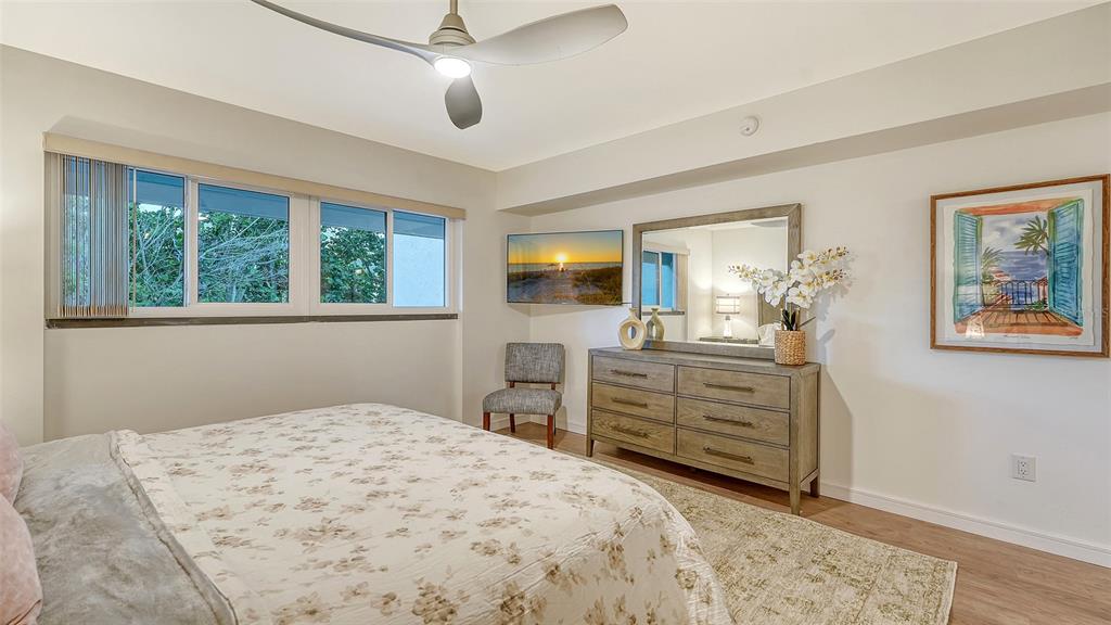 5757 Gulf Of Mexico Drive, Unit 204 Longboat Key, FL 34228 - Photo 45 of 71 a bedroom with a bed dresser and a window