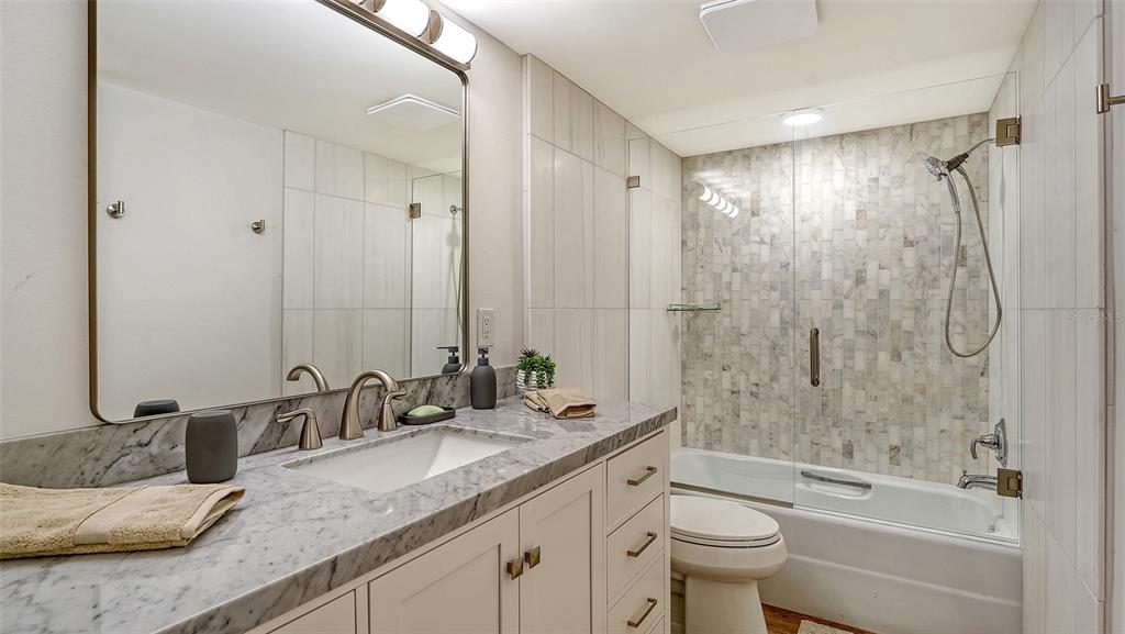 5757 Gulf Of Mexico Drive, Unit 204 Longboat Key, FL 34228 - Photo 47 of 71 a bathroom with a granite countertop sink a toilet and shower