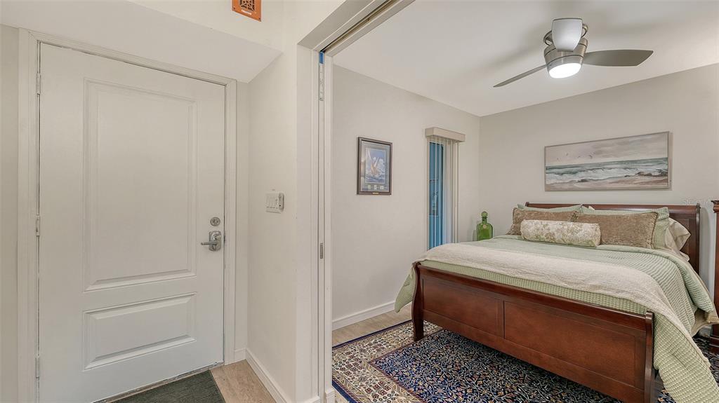 5757 Gulf Of Mexico Drive, Unit 204 Longboat Key, FL 34228 - Photo 49 of 71 a room with a bed and a painting on the wall