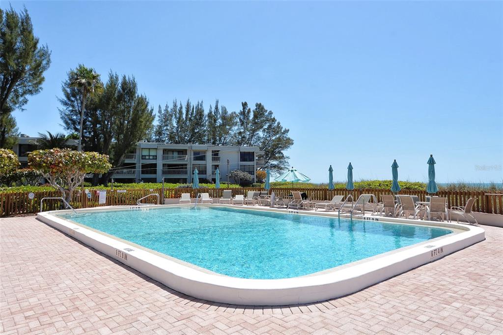 5757 Gulf Of Mexico Drive, Unit 204 Longboat Key, FL 34228 - Photo 62 of 71 a view of a swimming pool with outdoor seating