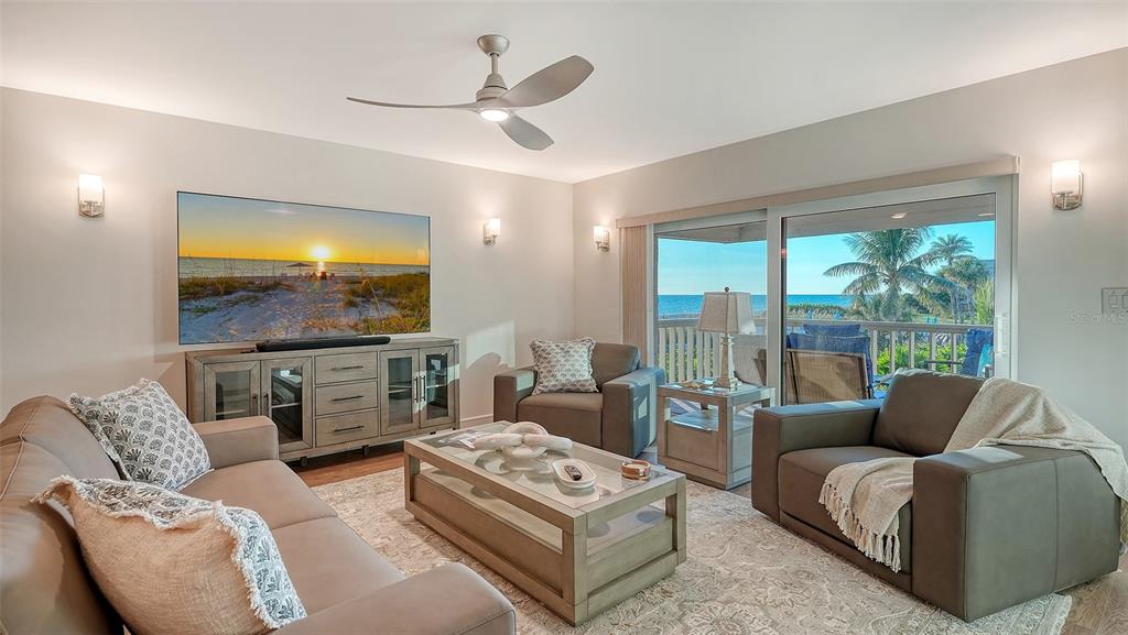 5757 Gulf Of Mexico Drive, Unit 204 Longboat Key, FL 34228 - Photo 8 of 71 a living room with furniture and a flat screen tv
