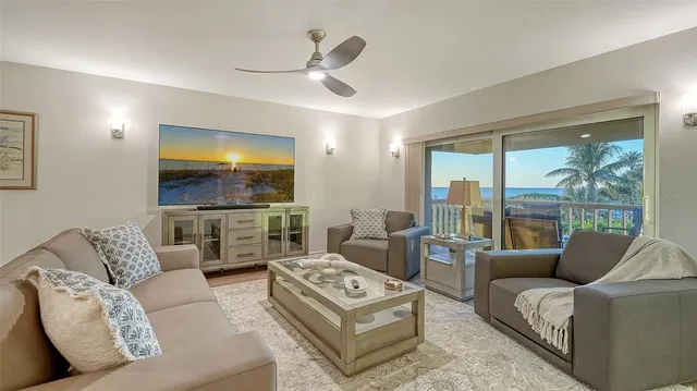 a balcony with wooden floor and outdoor seating