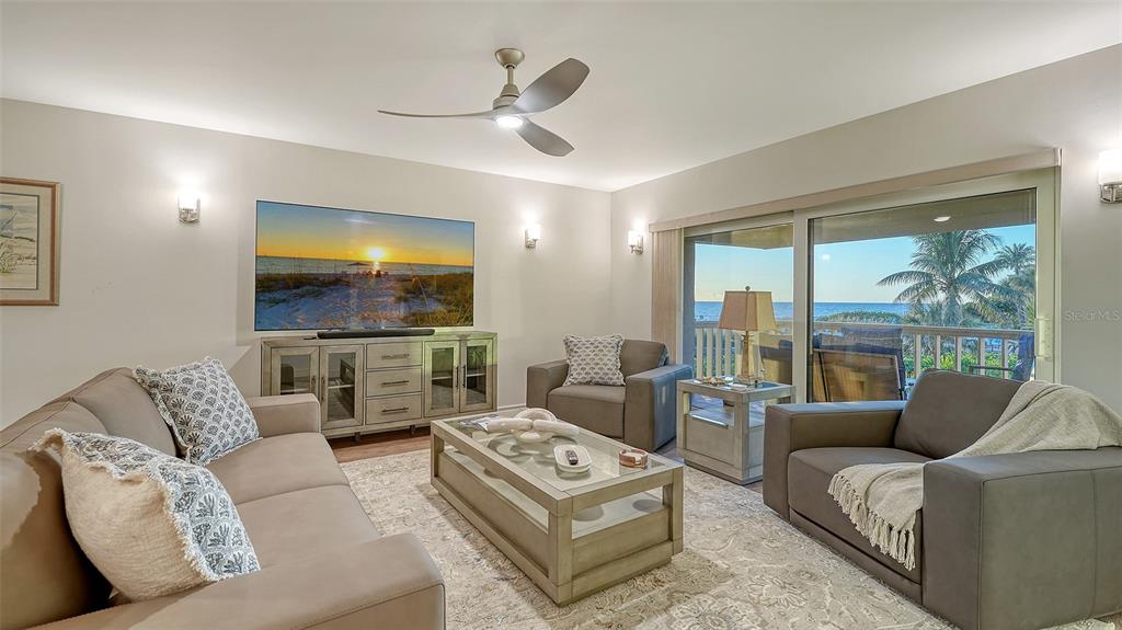 5757 Gulf Of Mexico Drive, Unit 204 Longboat Key, FL 34228 - Photo 10 of 71 a living room with furniture and a flat screen tv