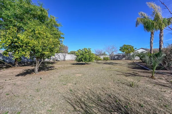 an empty room with windows and mirror