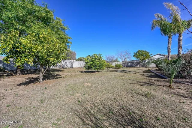 an empty room with windows and mirror