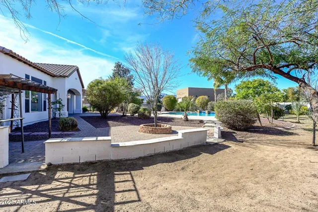 a view of a livingroom with a chandelier fan and wooden floor