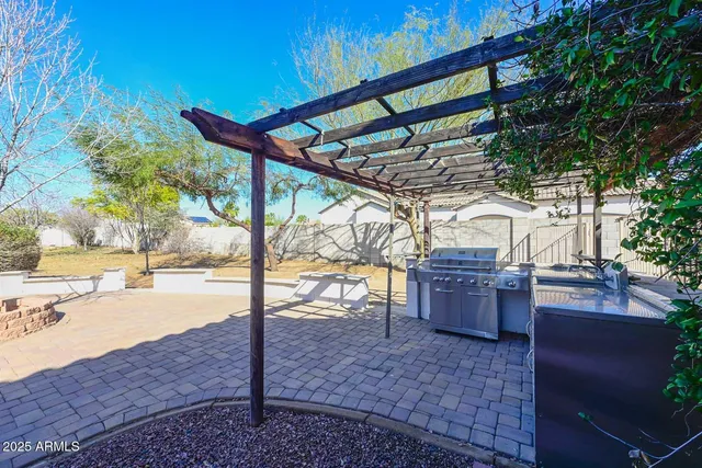 a bathroom with a granite countertop sink and mirror with bathtub
