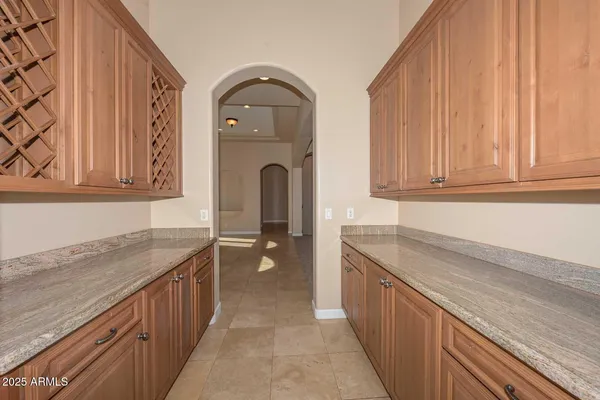a view of an empty room with a fireplace and a chandelier