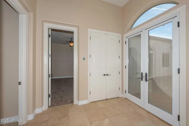 an empty room with a window and a fan