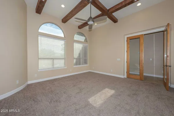 a bathroom with a granite countertop double vanity sink a mirror a bathtub and shower