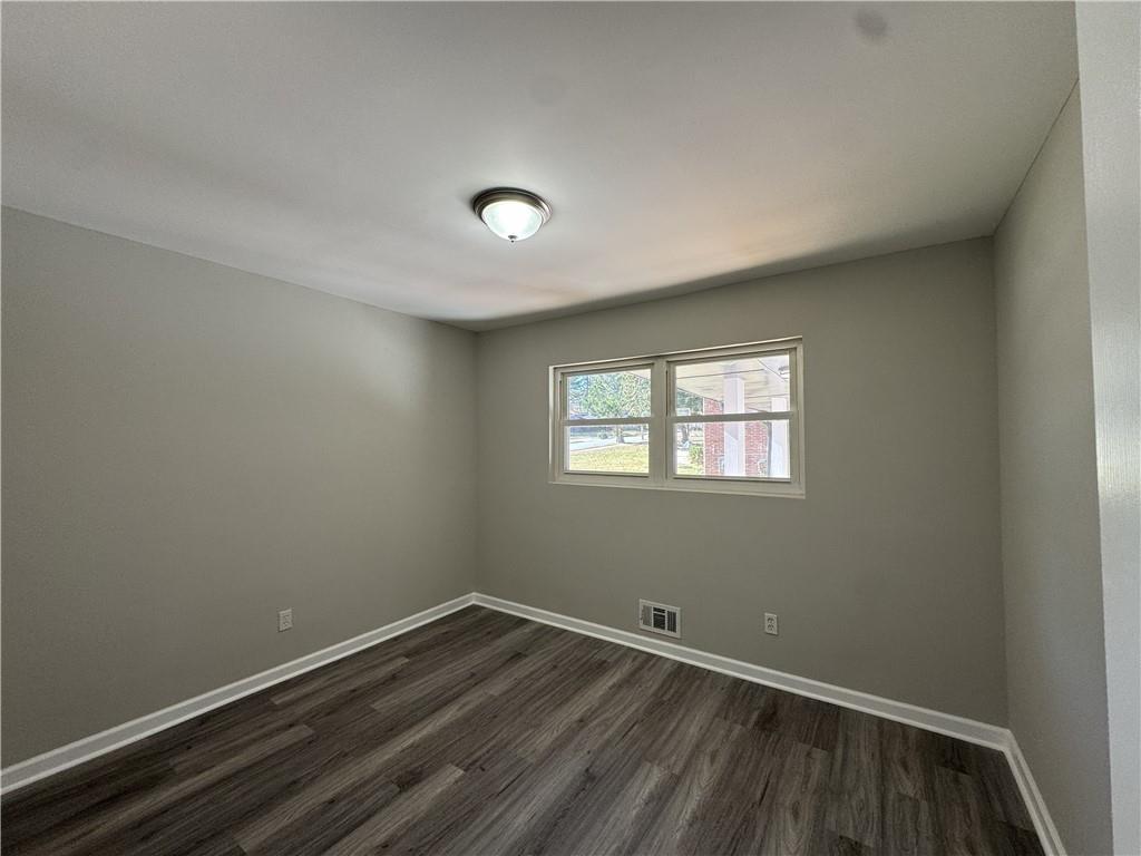 3489 Creighton Road Southwest Atlanta, GA 30331 - Photo 12 of 53 an empty room with wooden floor and windows