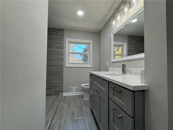 a bathroom with a sink toilet and shower