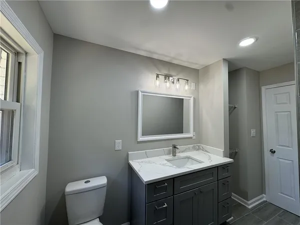 a bathroom with a sink a vanity and a mirror