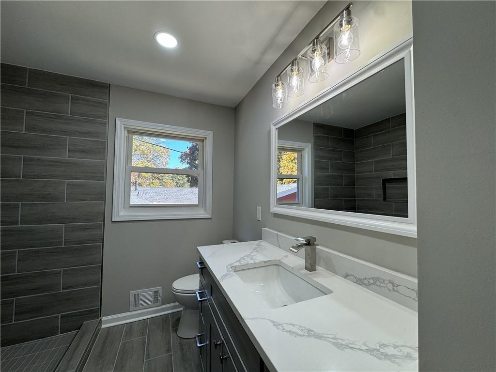 3489 Creighton Road Southwest Atlanta, GA 30331 - Photo 23 of 53 a bathroom with a sink a toilet and a mirror